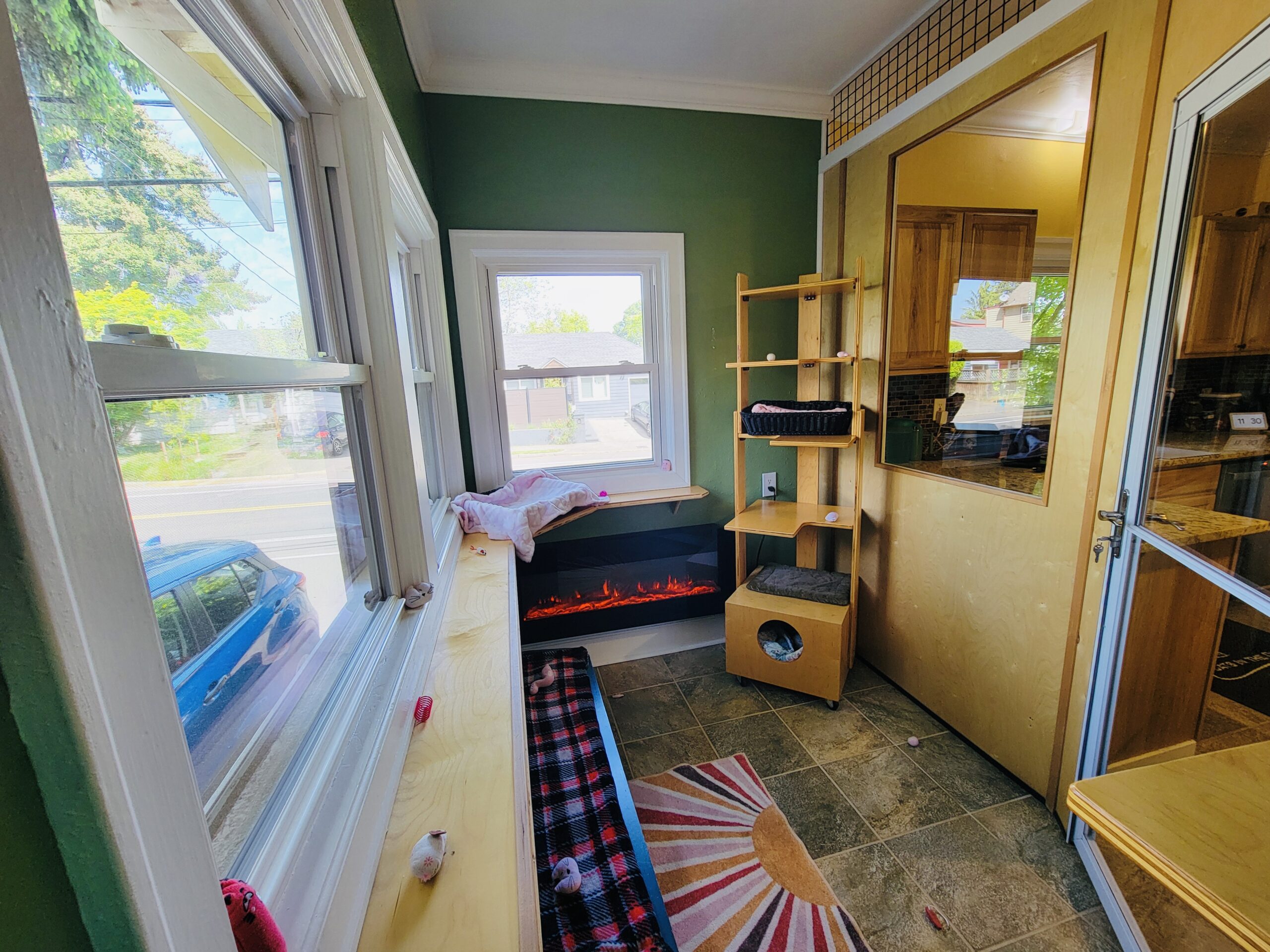 Private master bedroom with wall of windows, vertical ramps, and open floor area at Cats in the City Sellwood Portland